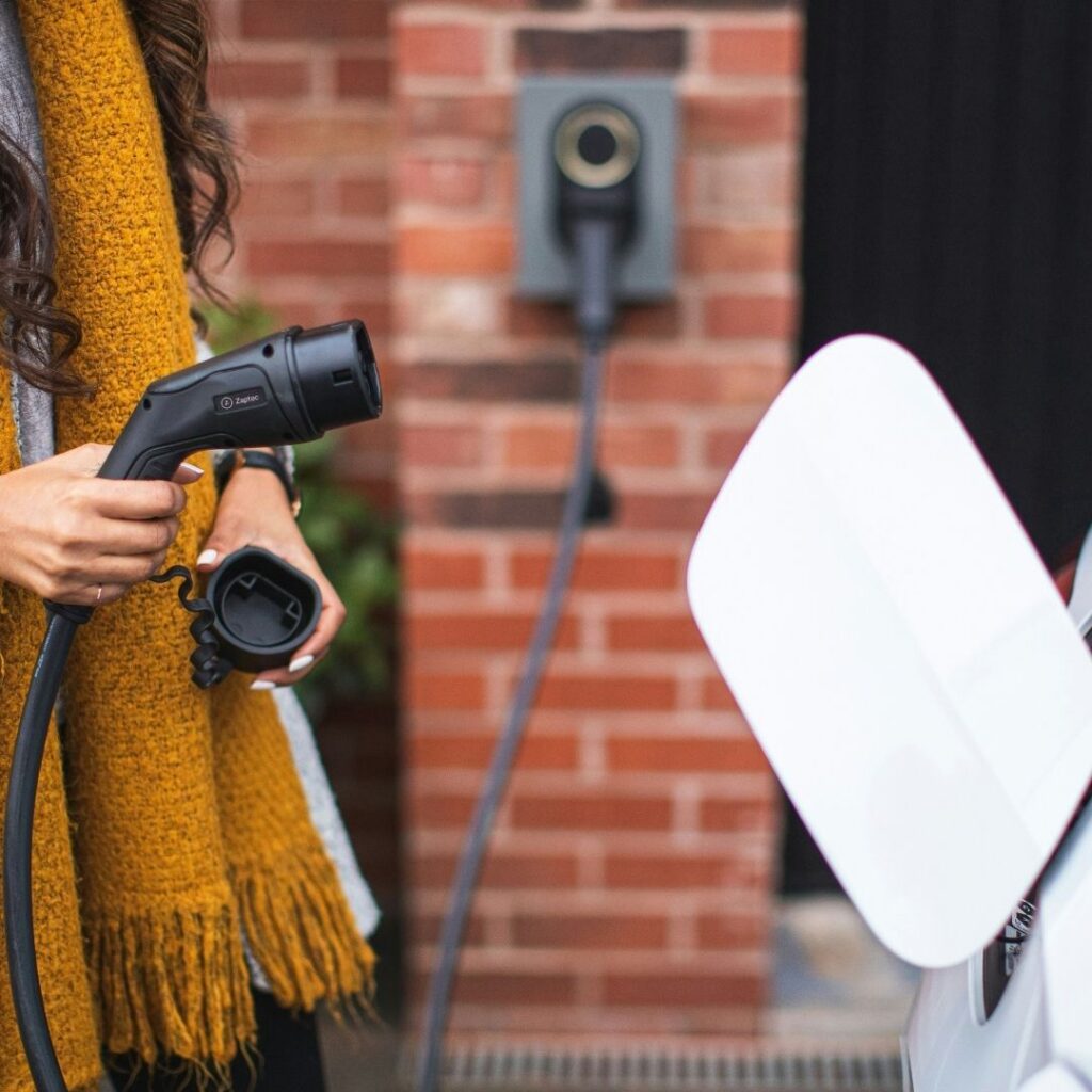 Person holding a EV Charger
